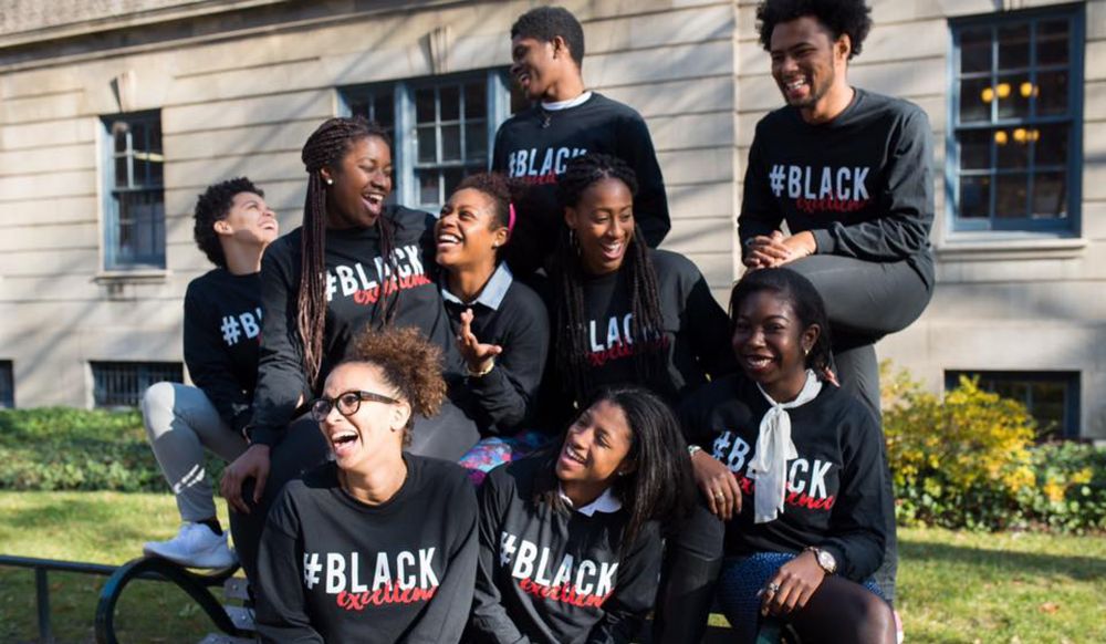 Students hanging out outside wearing matching shirts