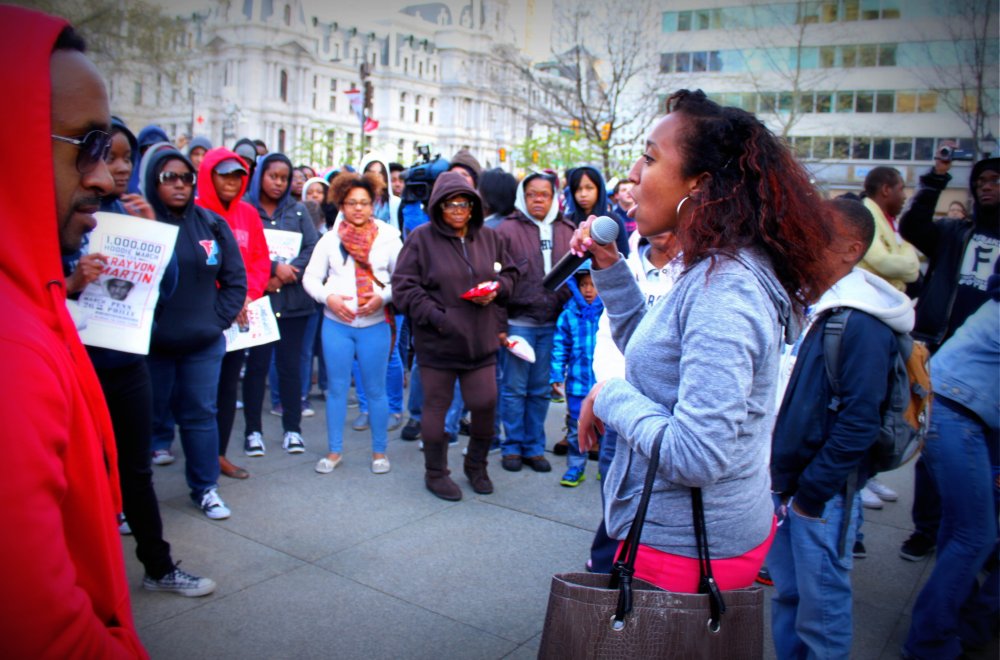 Student talking to a large crowd of students