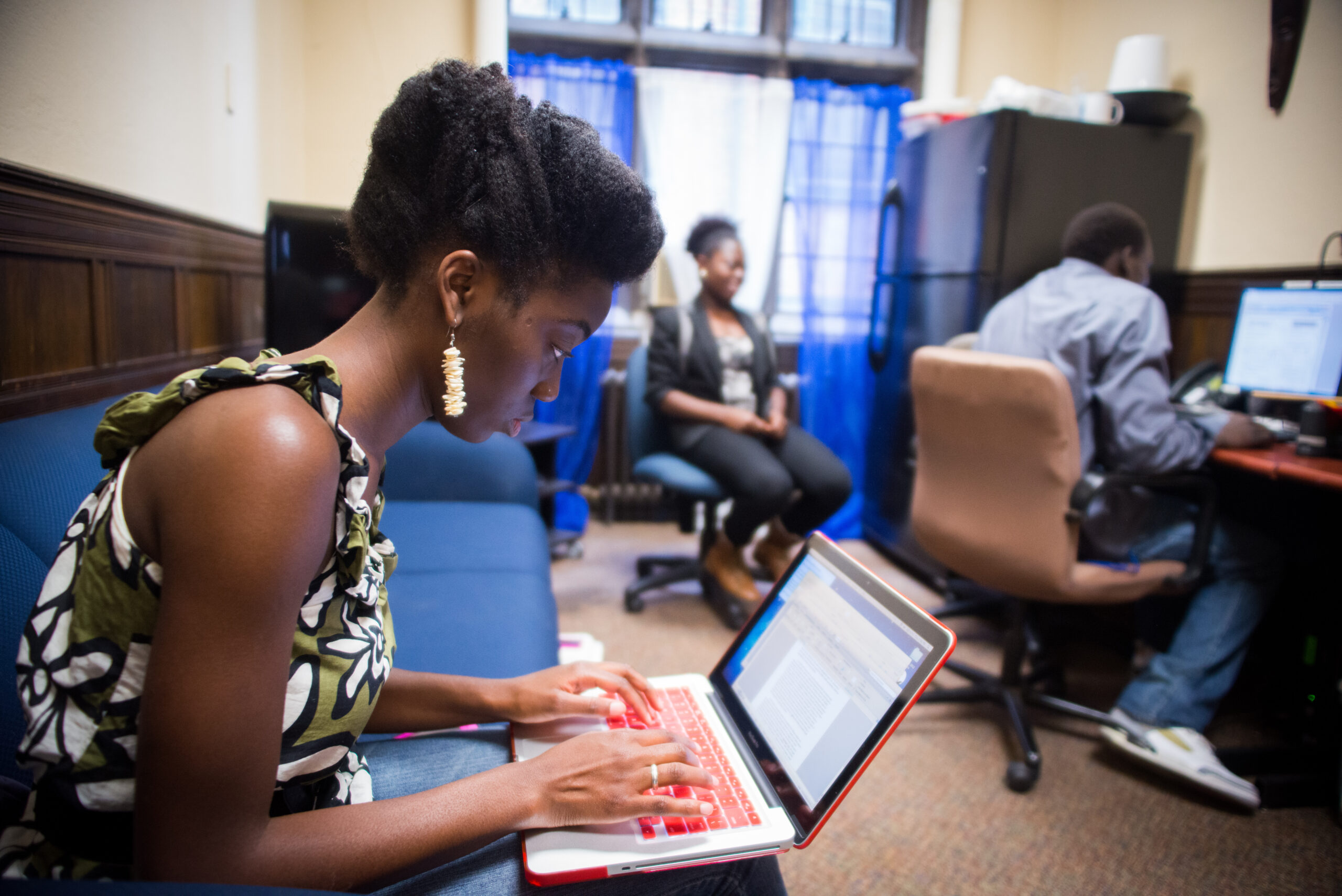 Student typing a paper on a laptop