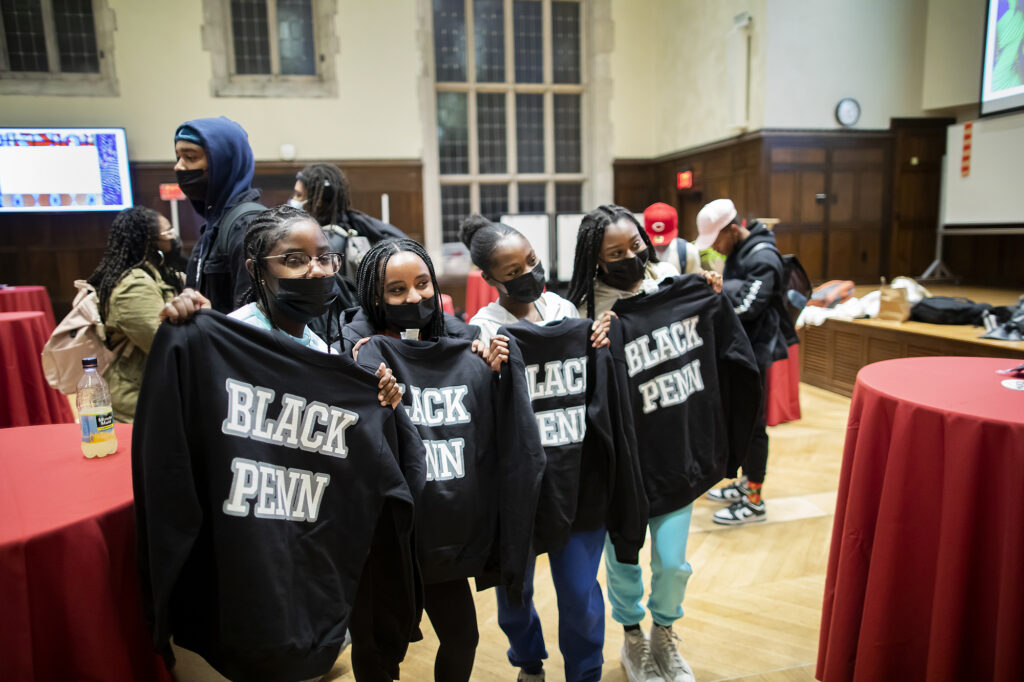 Students showing their new Black Penn sweatshirts